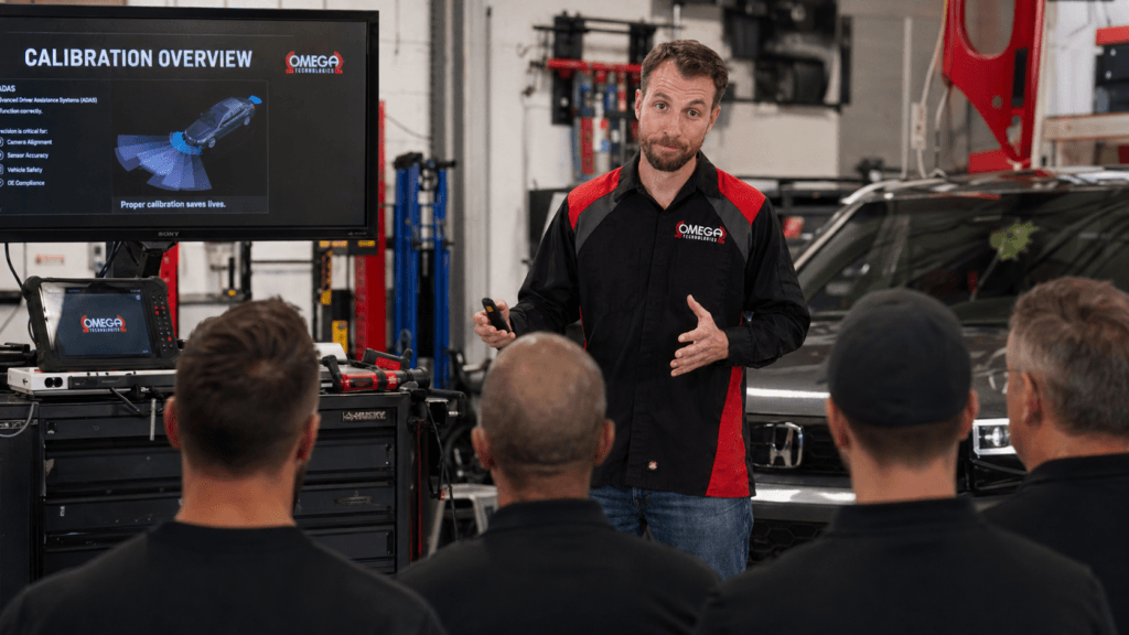 Picture of the Omega Tech Academy Head Instructor delivering on site training in a local body shop.
